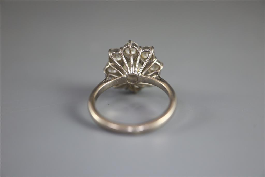 A 1970s 18ct white gold and nine stone diamond cluster ring,